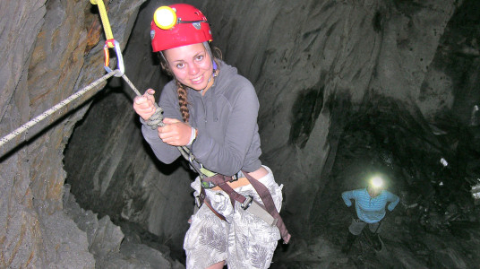 Picture of a young woman caving in a disused slate mine in Snowdonia Wales UK